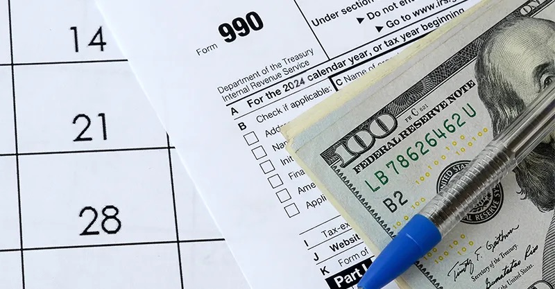 Tax refund paperwork with cash around it